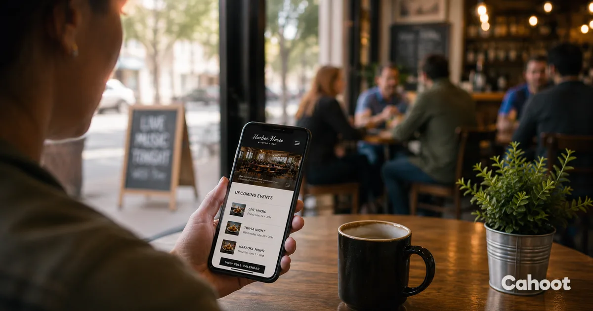 A customer checking a local business website on their phone inside a coffee shop.